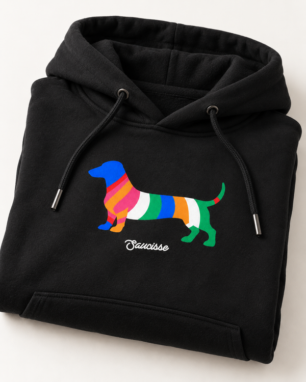 Black Saucisse Colour Me Dachshund hoodie folded to show the colourful striped dachshund front print and white Saucisse signature.
