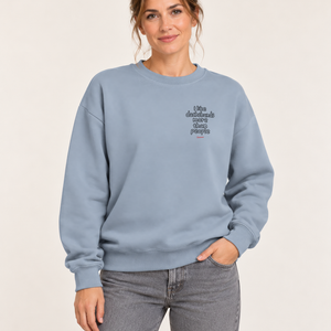 Woman wearing the Aquamarine Saucisse I Like Dachshunds More Than People sweater, front view with a small outline chest print and red signature.