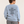 Rear studio view of the Aquamarine Saucisse I Like Dachshunds More Than People sweater, with outline lettering and a red Saucisse signature.