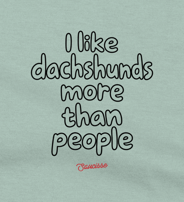 Close-up of the front print on the Aloe Saucisse I Like Dachshunds More Than People T-shirt, showing the original outline lettering and red signature.