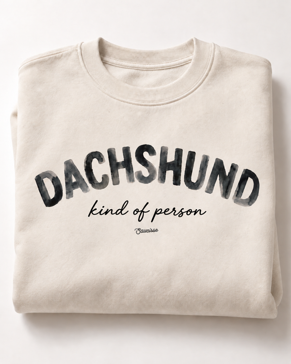 Folded ivory Dachshund Kind of Person sweatshirt