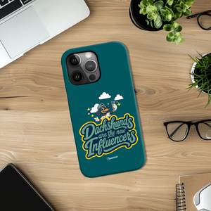 Saucisse teal case with Dachshunds Are the New Influencers lettering and dachshund artwork, on a wooden desk.