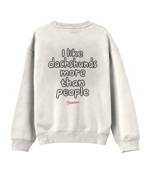 Ivory Saucisse I Like Dachshunds More Than People unisex sweater, rear view with centred outline lettering and a red signature.