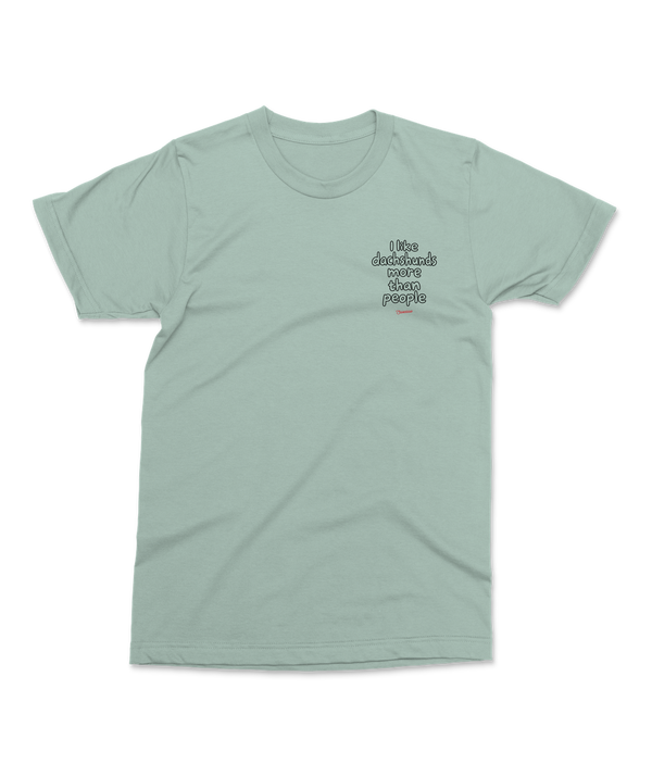 Aloe Saucisse I Like Dachshunds More Than People unisex T-shirt, front view with a small left-chest outline print and red Saucisse signature.