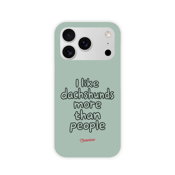 Saucisse sage-green high gloss phone case with “I like dachshunds more than people” lettering and a red signature.