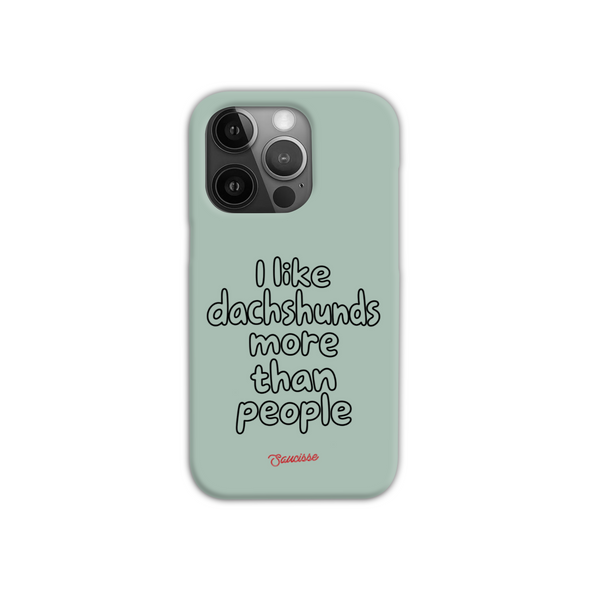 Saucisse sage-green phone case for iPhone 16 Pro, with “I like dachshunds more than people” lettering and a red signature.