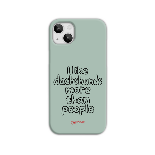 Saucisse sage-green phone case for iPhone 14 Plus, with “I like dachshunds more than people” lettering and a red signature.