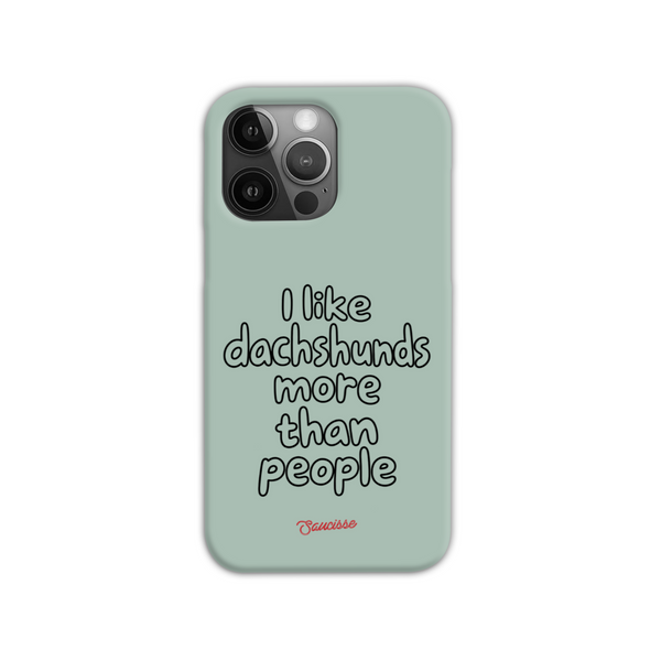 Saucisse sage-green phone case for iPhone 14 Pro Max, with “I like dachshunds more than people” lettering and a red signature.