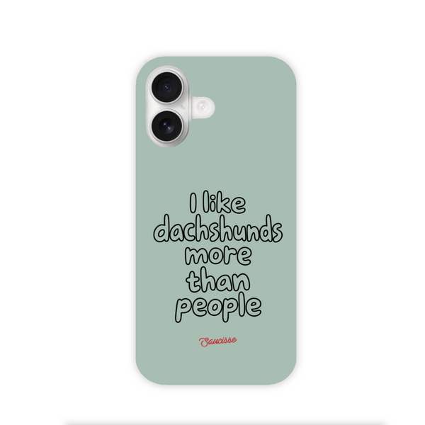Saucisse sage-green phone case for iPhone 17, with “I like dachshunds more than people” lettering and a red signature.