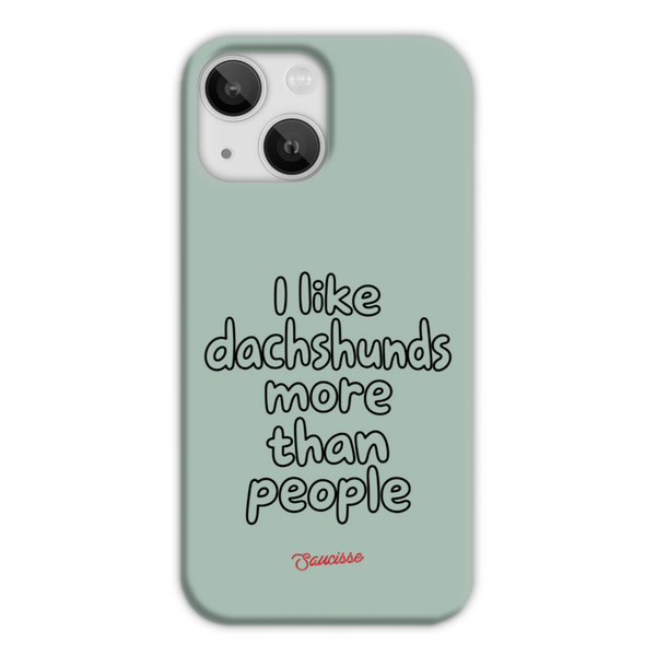 Saucisse sage-green phone case for iPhone 13, with “I like dachshunds more than people” lettering and a red signature.