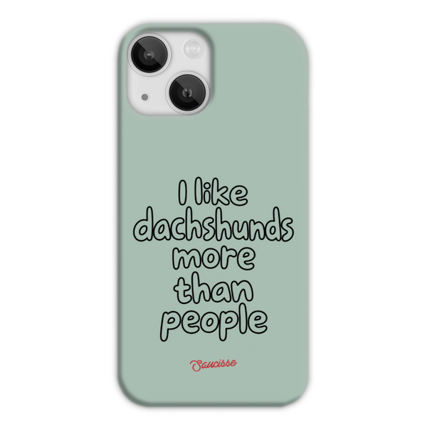 Saucisse sage-green phone case for iPhone 13 Mini, with “I like dachshunds more than people” lettering and a red signature.