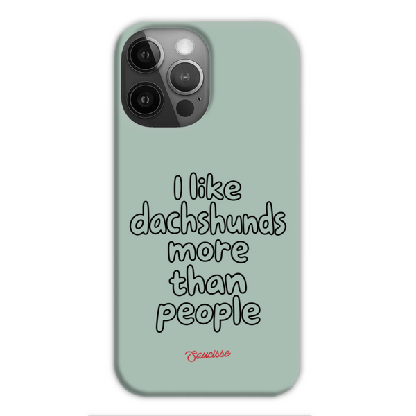 Saucisse sage-green phone case for iPhone 13 Pro Max, with “I like dachshunds more than people” lettering and a red signature.