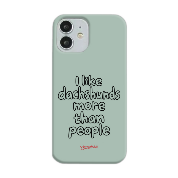 Saucisse sage-green phone case for iPhone 12, with “I like dachshunds more than people” lettering and a red signature.