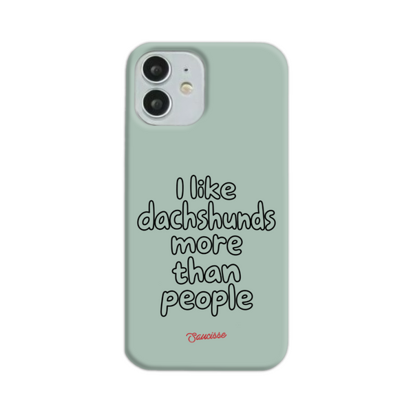 Saucisse sage-green phone case for iPhone 12 Mini, with “I like dachshunds more than people” lettering and a red signature.