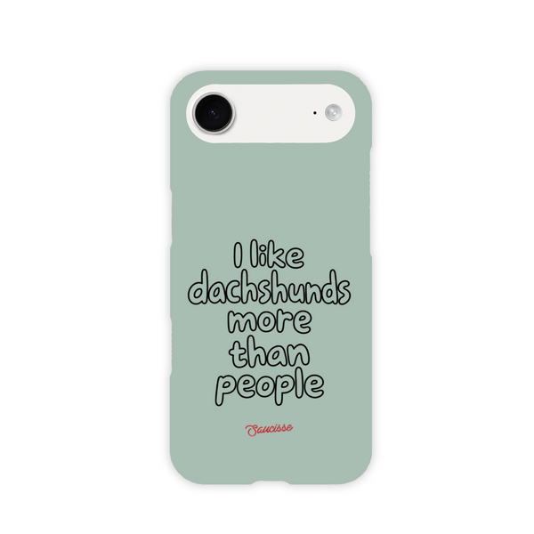 Saucisse sage-green phone case for iPhone 17 AIR, with “I like dachshunds more than people” lettering and a red signature.