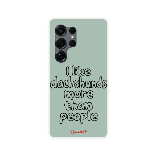 Saucisse sage-green phone case for Galaxy S25 Ultra, with “I like dachshunds more than people” lettering and a red signature.