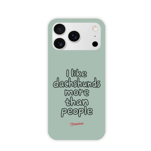 Saucisse sage-green phone case for iPhone 17 Pro Max, with “I like dachshunds more than people” lettering and a red signature.