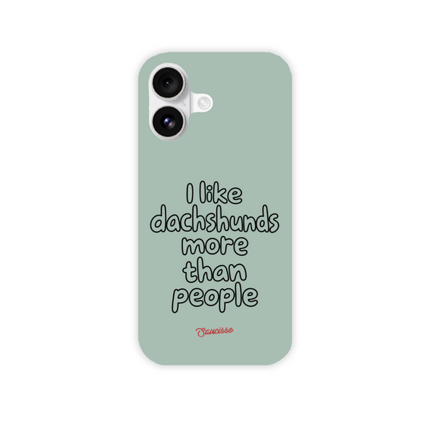 Saucisse sage-green phone case for iPhone 16, with “I like dachshunds more than people” lettering and a red signature.