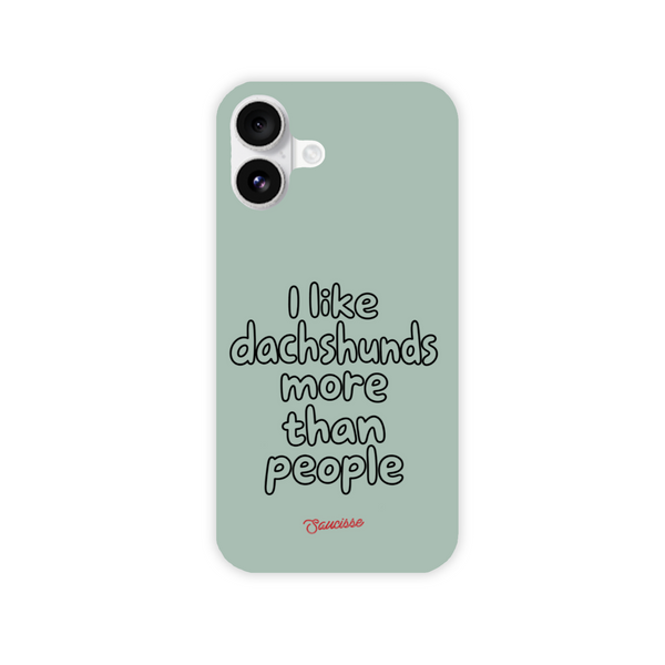 Saucisse sage-green phone case for iPhone 16 Plus, with “I like dachshunds more than people” lettering and a red signature.