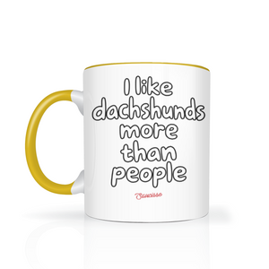Saucisse I Like Dachshunds More Than People mug in Yellow, with black outline I Like Dachshunds More Than People lettering and a red Saucisse signature.