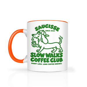 Saucisse Slow Walks Coffee Club mug in Orange, with green dachshund artwork and Slow Walks Coffee Club lettering.