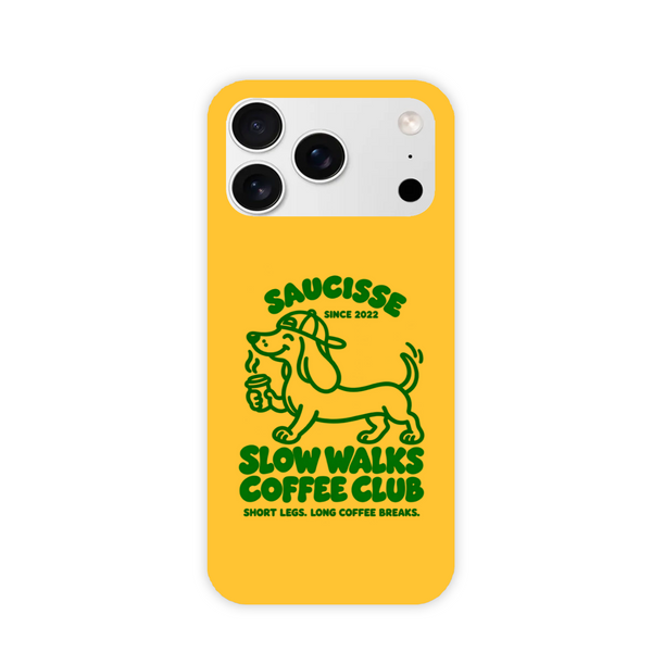 Saucisse yellow case with green dachshund artwork and Slow Walks Coffee Club lettering, showing the printed back and model-specific camera opening.
