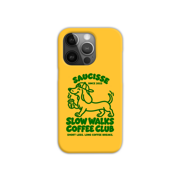 Saucisse yellow case with green dachshund artwork and Slow Walks Coffee Club lettering, showing the printed back and model-specific camera opening.