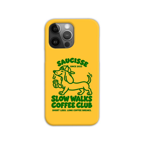 Saucisse yellow case with green dachshund artwork and Slow Walks Coffee Club lettering, showing the printed back and model-specific camera opening.