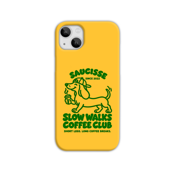 Saucisse yellow case with green dachshund artwork and Slow Walks Coffee Club lettering, showing the printed back and model-specific camera opening.