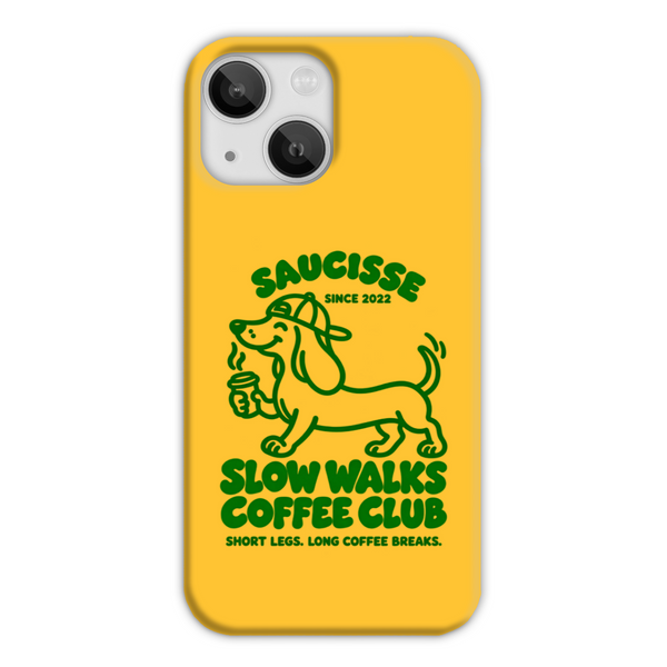 Saucisse yellow case with green dachshund artwork and Slow Walks Coffee Club lettering, showing the printed back and model-specific camera opening.