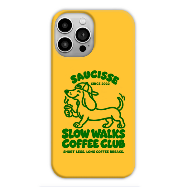 Saucisse yellow case with green dachshund artwork and Slow Walks Coffee Club lettering, showing the printed back and model-specific camera opening.
