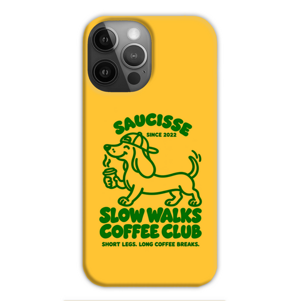 Saucisse yellow case with green dachshund artwork and Slow Walks Coffee Club lettering, showing the printed back and model-specific camera opening.