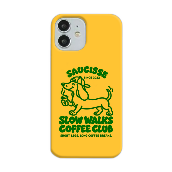 Saucisse yellow case with green dachshund artwork and Slow Walks Coffee Club lettering, showing the printed back and model-specific camera opening.