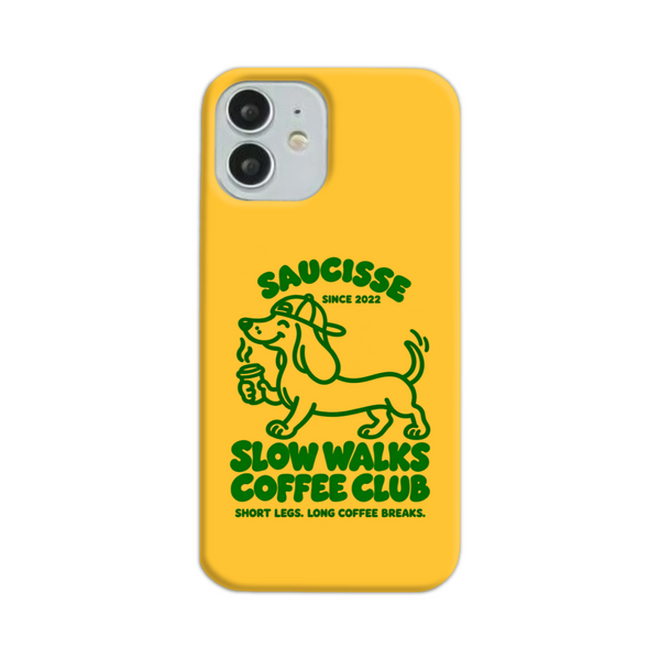 Saucisse yellow case with green dachshund artwork and Slow Walks Coffee Club lettering, showing the printed back and model-specific camera opening.