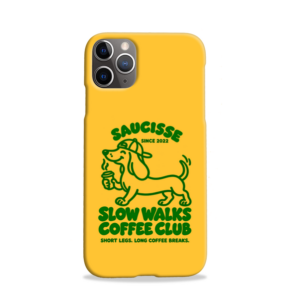 Saucisse yellow case with green dachshund artwork and Slow Walks Coffee Club lettering, showing the printed back and model-specific camera opening.