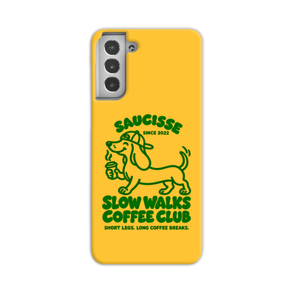 Saucisse yellow case with green dachshund artwork and Slow Walks Coffee Club lettering, showing the printed back and model-specific camera opening.