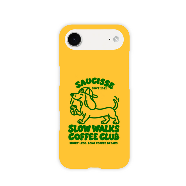 Saucisse yellow case with green dachshund artwork and Slow Walks Coffee Club lettering, showing the printed back and model-specific camera opening.