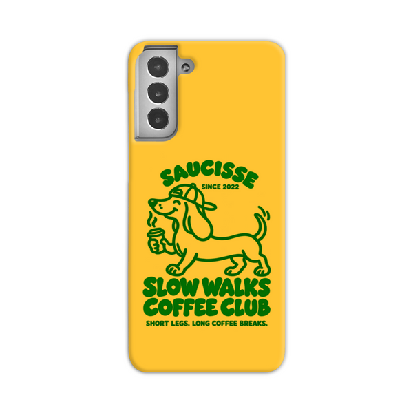 Saucisse yellow case with green dachshund artwork and Slow Walks Coffee Club lettering, showing the printed back and model-specific camera opening.