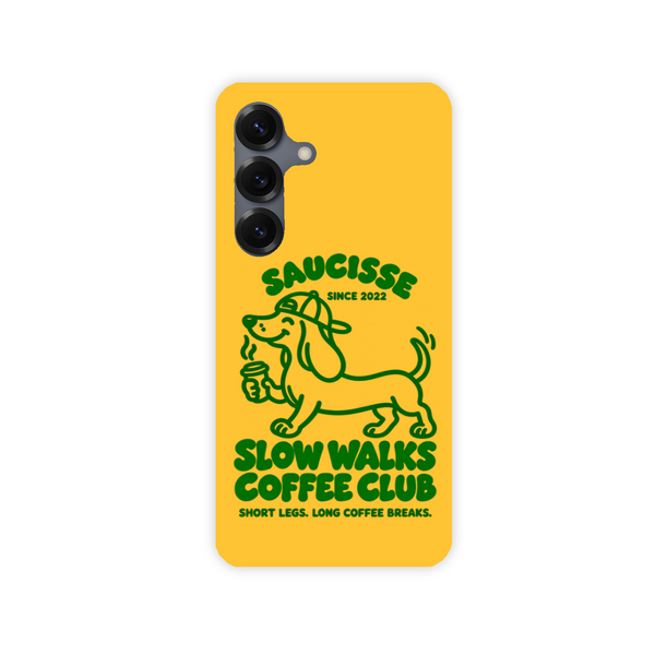 Saucisse yellow case with green dachshund artwork and Slow Walks Coffee Club lettering, showing the printed back and model-specific camera opening.