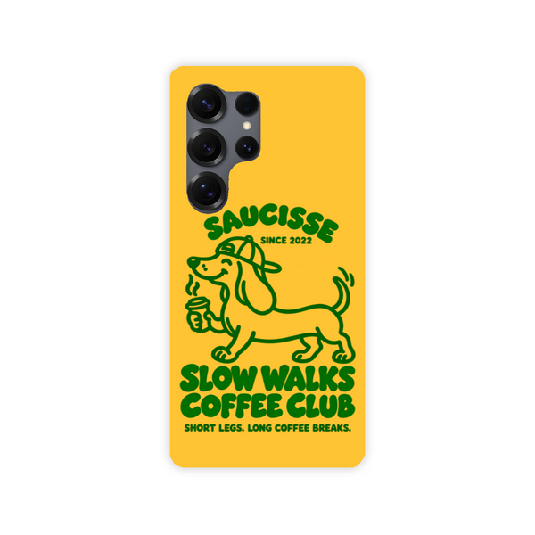 Saucisse yellow case with green dachshund artwork and Slow Walks Coffee Club lettering, showing the printed back and model-specific camera opening.