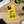 Saucisse yellow case with green dachshund artwork and Slow Walks Coffee Club lettering, on a wooden desk.