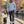 Dachshund owner wearing the Aquamarine Saucisse Manchester England hoodie on a canal walk with a black-and-tan dachshund.