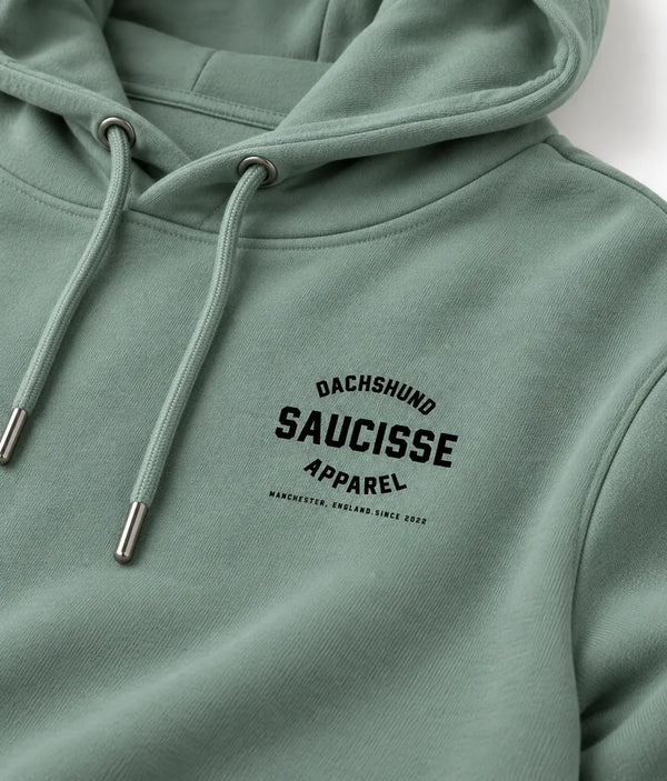 Close-up of the Jade Green Saucisse hoodie chest print, cotton texture and matching drawcords with metal tips.