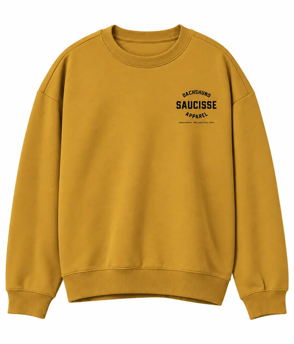 Front of Saucisse Manchester England unisex sweater in Curcuma, with small black left-chest Dachshund Apparel logo