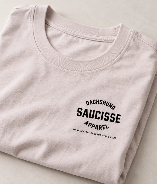 Close-up of the black Saucisse Manchester England print and cotton fabric on the Vintage White T-shirt