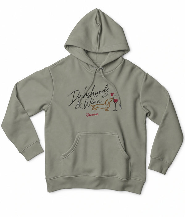 Front view of the Almond Green Saucisse Dachshunds & Wine women's hoodie, with matching drawcords and a centred dachshund and wine print.