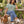 Woman wearing the Aloe Dachshunds & Wine T-shirt in a garden with a dachshund
