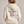 Woman wearing the Saucisse I Like Dachshunds More Than People Ivory hoodie, rear studio view with approved print scale