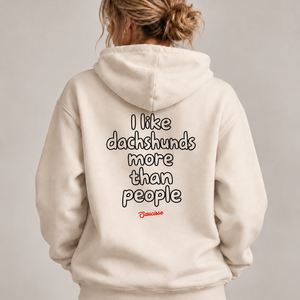 Woman wearing the Saucisse I Like Dachshunds More Than People Ivory hoodie, rear studio view with approved print scale