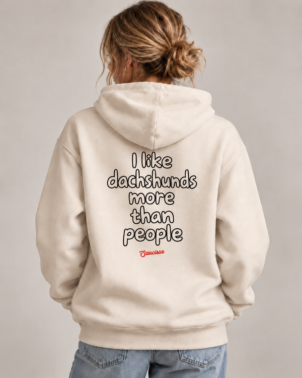 Woman wearing the Saucisse I Like Dachshunds More Than People Ivory hoodie, rear studio view with approved print scale